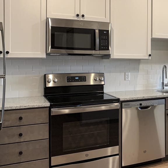 Thumbnail 5 of 8 kitchen with white and gray cabinets and matching stainless steel appliances