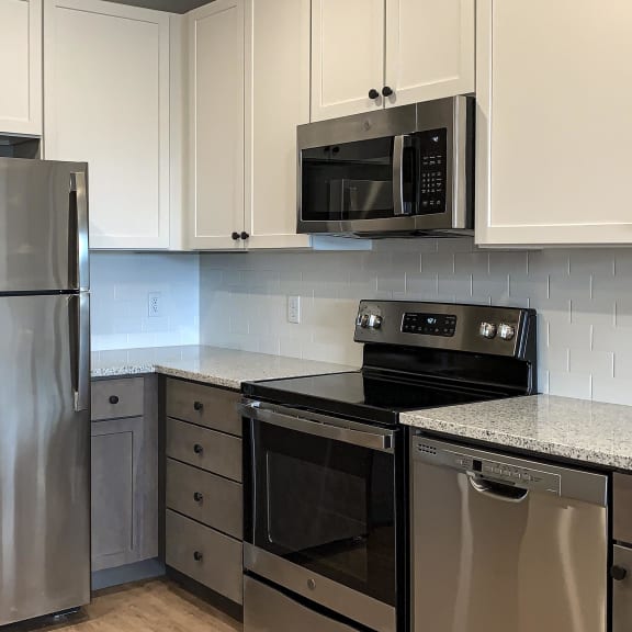 Thumbnail 4 of 8 kitchen with white and gray cabinets and matching stainless steel appliances