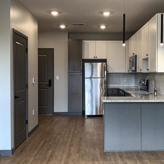 Thumbnail 2 of 8 kitchen with white and gray cabinets and matching stainless steel appliances