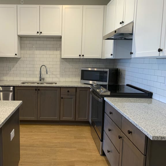 Thumbnail 4 of 13 Luxury kitchen with matching stainless steel appliances and large granite counters at Haven at Uptown in Lincoln, Nebraska