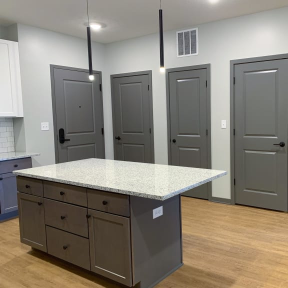 Thumbnail 5 of 13 Luxury kitchen with matching stainless steel appliances and large granite counters at Haven at Uptown in Lincoln, Nebraska