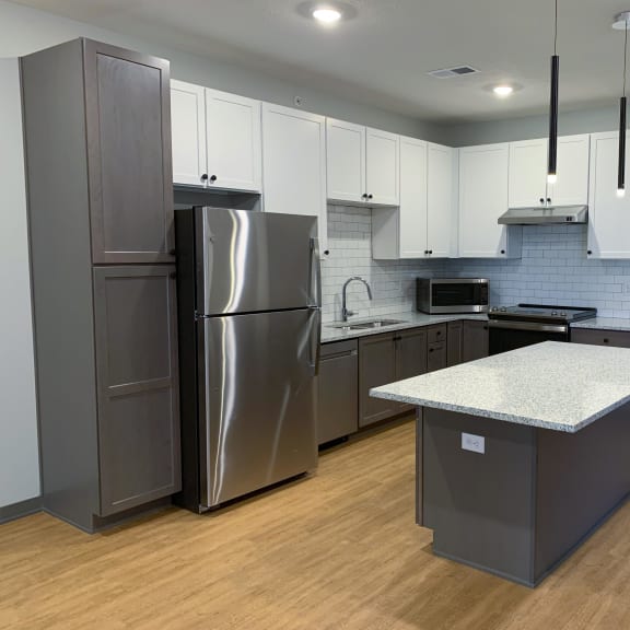 Thumbnail 3 of 13 Luxury kitchen with matching stainless steel appliances and large granite counters at Haven at Uptown in Lincoln, Nebraska