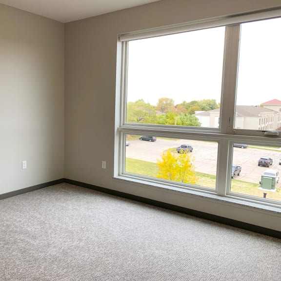 Thumbnail 9 of 13 carpeted bedroom with huge window