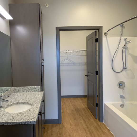 Thumbnail 12 of 13 Spacious bathroom with shower tub combo walk in closet attached at Haven at Uptown in Lincoln, Nebraska