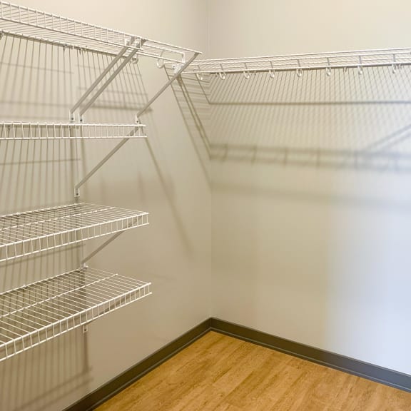 Thumbnail 8 of 13 large walk in closet with rods and shelving for storage and hanging space
