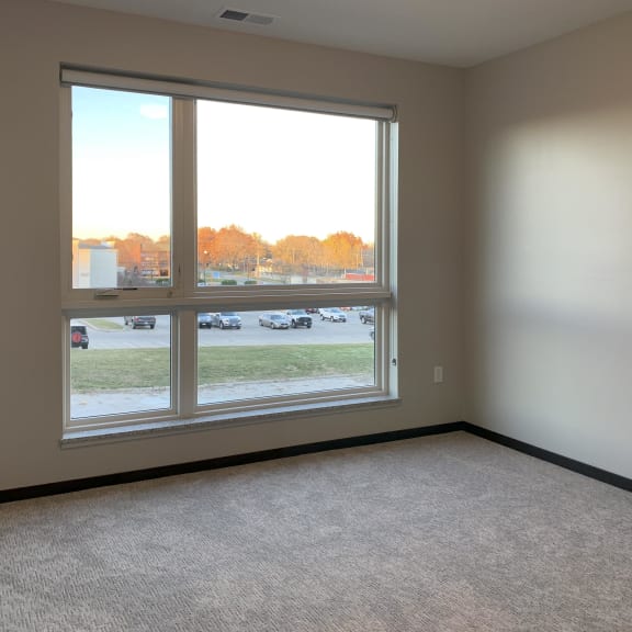 Thumbnail 12 of 18 carpeted master bedroom with large floor to ceiling window