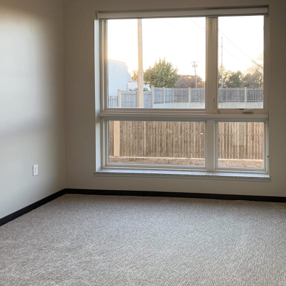 Thumbnail 9 of 18 Carpeted bedroom with large floor to ceiling window