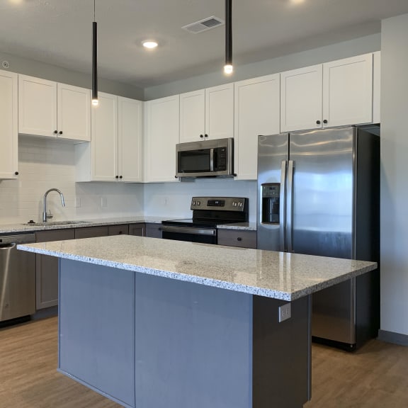 Thumbnail 3 of 16 Kitchen with white upper cabinets and gray lower cabinets at Haven at Uptown