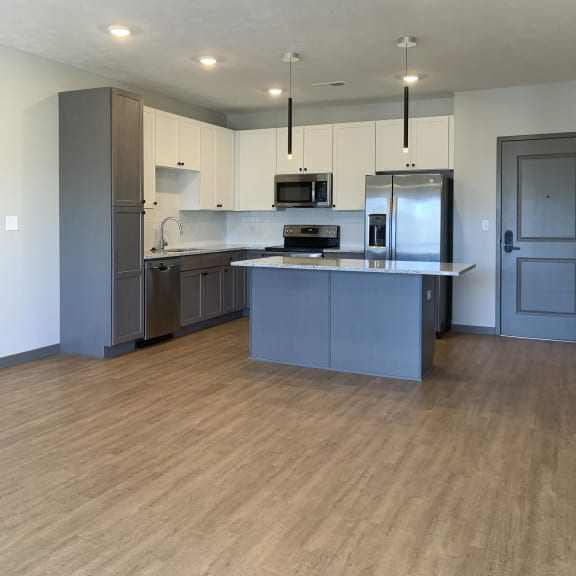 Thumbnail 6 of 16 Kitchen with white upper cabinets and gray lower cabinets at Haven at Uptown