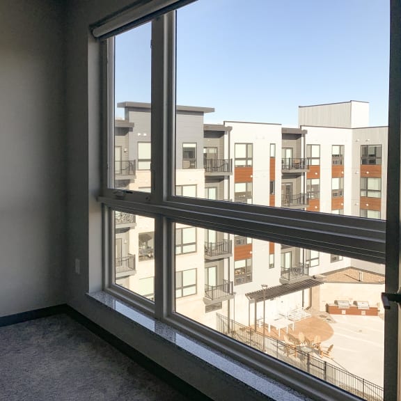 Thumbnail 9 of 16 Master bedroom with large floor-to-ceiling window at Haven at uptown