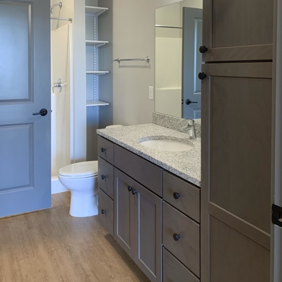 Thumbnail 13 of 16 Large bathroom with standing shower and storage shelves at Haven at Uptown