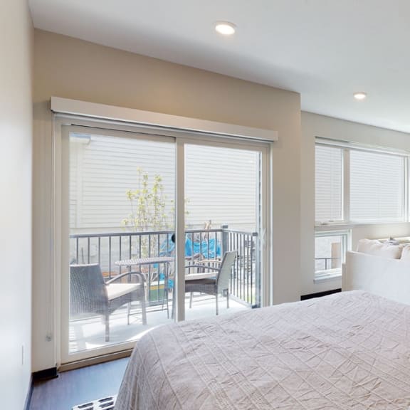 Thumbnail 9 of 23 a studio apartment with a large bed and a tv on the wall
