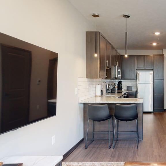 Thumbnail 4 of 23 a kitchen a with two bar stools at the counter