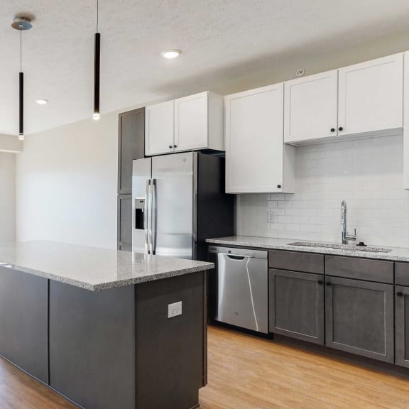 Thumbnail 12 of 19 Open concept kitchen and living space in the Bliss floor plan at Haven at Uptown in Lincoln, NE