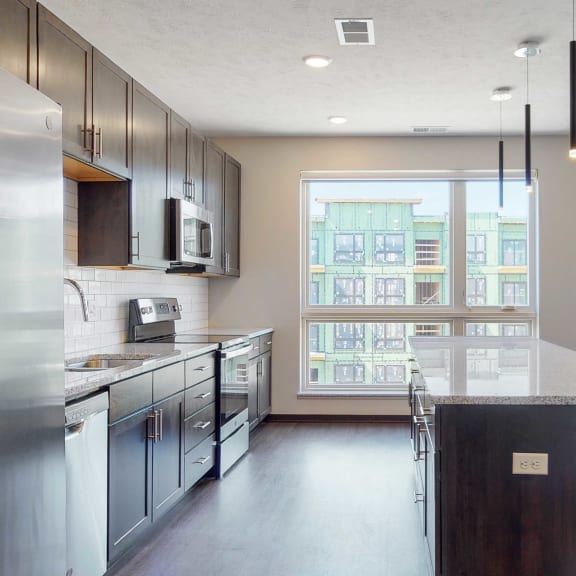 Thumbnail 3 of 17 Spacious kitchen with mocha finishes in the Melody floor plan at Haven at Uptown in Lincoln, NE