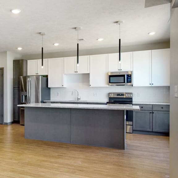 Thumbnail 10 of 17 Kitchen island provides additional seating in the Melody floor plan at Haven at Uptown in Lincoln, NE