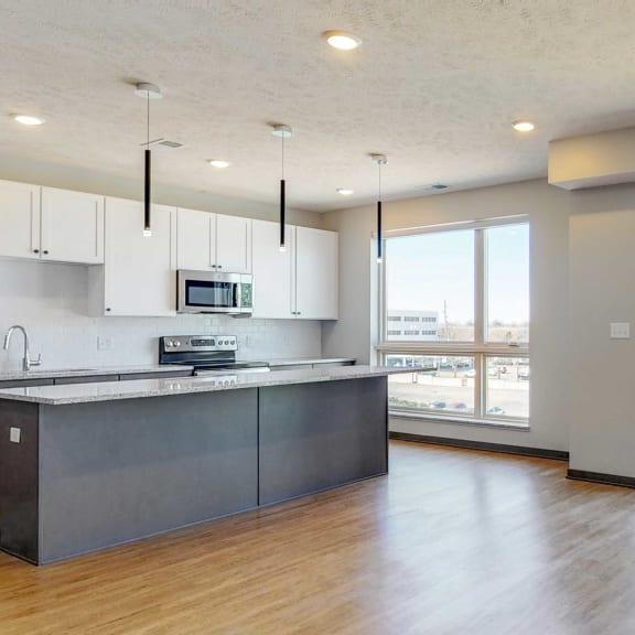 Thumbnail 11 of 17 Kitchen and living space with abundant natural light in the Melody floor plan at Haven at Uptown in Lincoln, NE