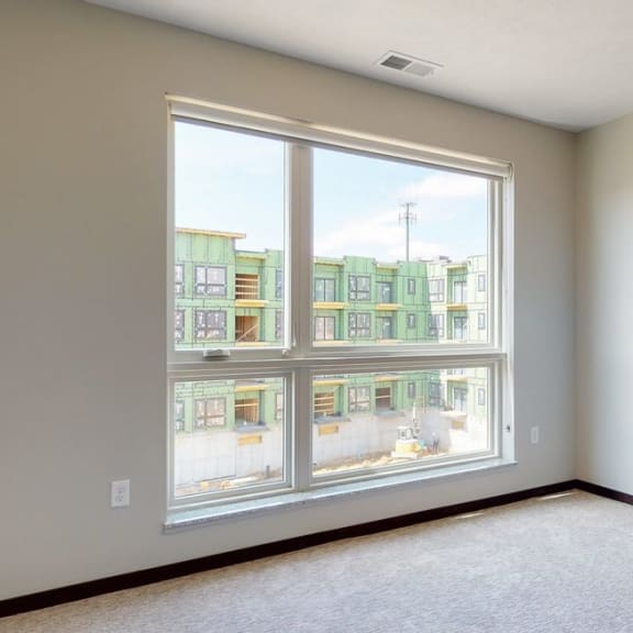 Thumbnail 6 of 18 Natural light in bedroom provided by large windows at Haven at Uptown in Lincoln, NE