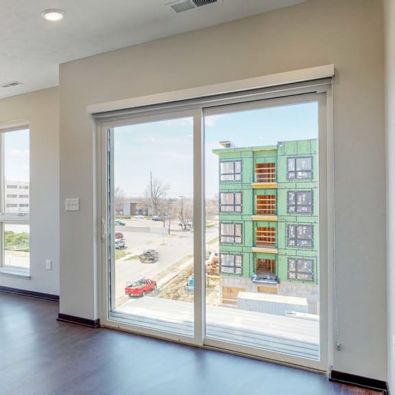 Thumbnail 5 of 18 Living space with sliding doors to balcony at Haven at Uptown in Lincoln, NE