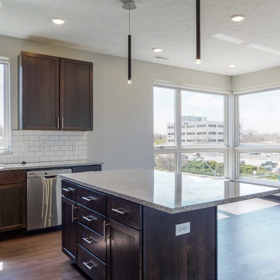 Thumbnail 3 of 18 Kitchen and living space with abundant natural light at Haven at Uptown in Lincoln, NE