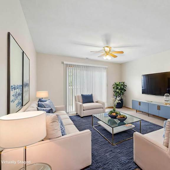 Thumbnail 2 of 16 Virtually staged living room with two armchairs, a wall-mounted TV, coffee table, sliding glass door, and neutral finishes.