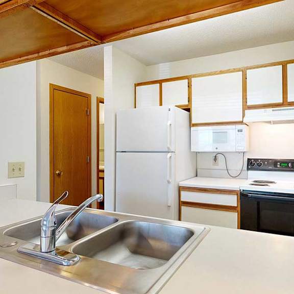 Thumbnail 12 of 29 Kitchen with white appliances, white and wooden cabinetry, and a double basin sink