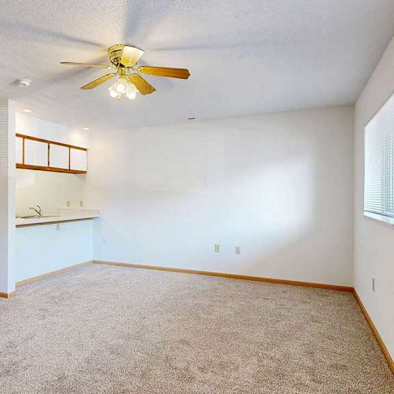 Thumbnail 10 of 29 Open living space with carpet flooring and ceiling fan