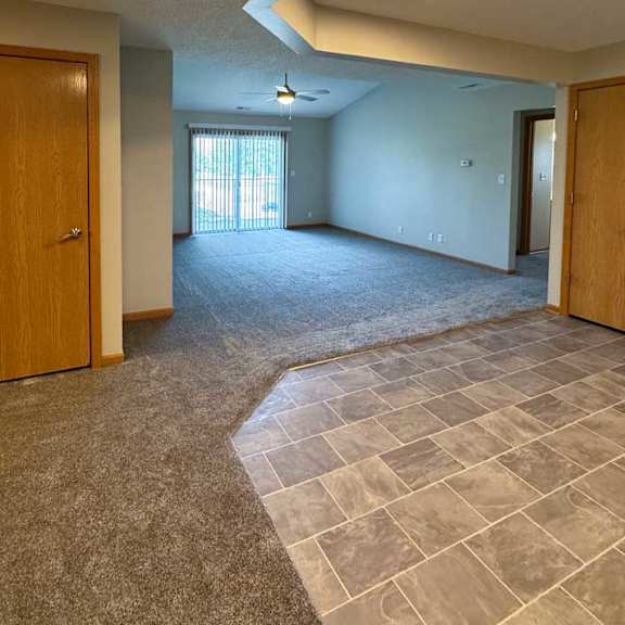 Thumbnail 12 of 18 a spacious living room next to an open kitchen with tiled flooring