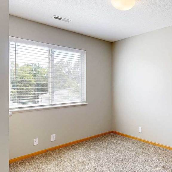 Thumbnail 17 of 28 a den space with carpeted flooring and a wide window