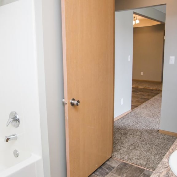 Thumbnail 11 of 11 a bathroom with a door open to a shower and a sink