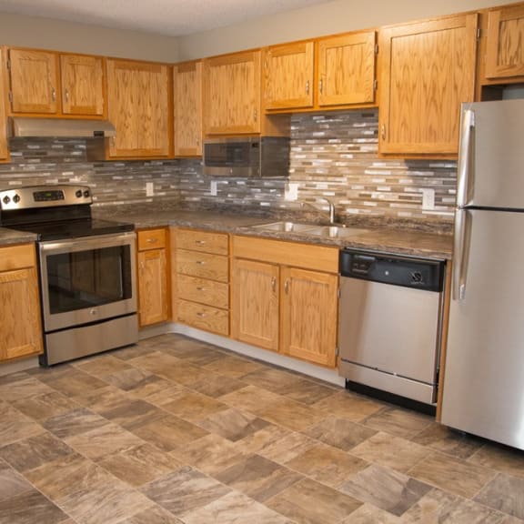 Thumbnail 4 of 11 a kitchen with wooden cabinets and stainless steel appliances