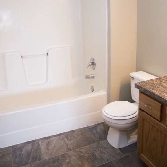 Thumbnail 8 of 11 a bathroom with a toilet and a tub and a sink