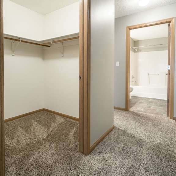 Thumbnail 10 of 14 a walk-in closet in the second bedroom and a door open to the attached bathroom
