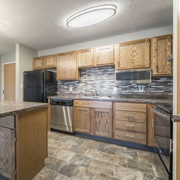 Thumbnail 3 of 14 a renovated kitchen with tile backsplash and new appliances