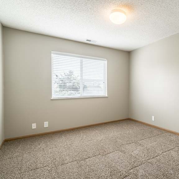 Thumbnail 8 of 14 an empty room with carpet and a window
