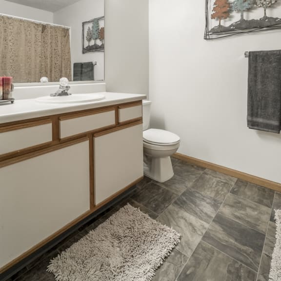 Thumbnail 10 of 10 Bathroom in non-renovated unit with white and wood cabinetry
