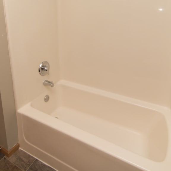 Thumbnail 10 of 10 a white bath tub in a bathroom with a shower curtain