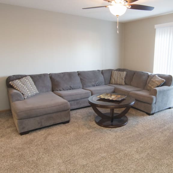 Thumbnail 5 of 10 a living room with a couch and a coffee table