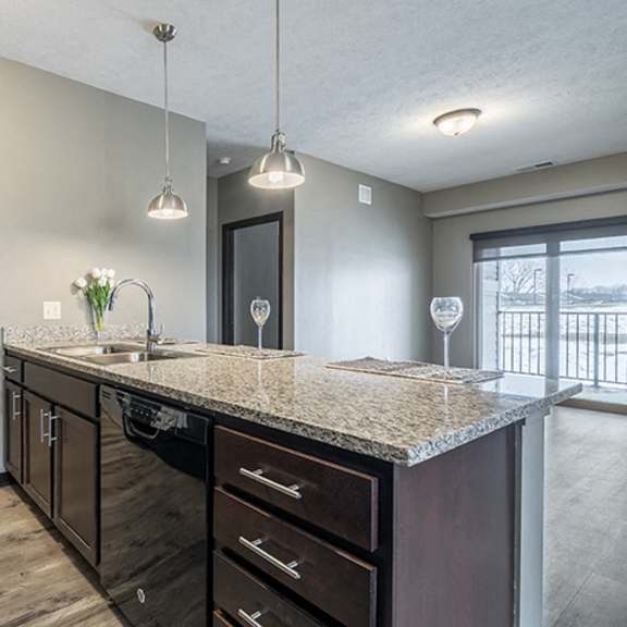 Thumbnail 5 of 12 Kitchen with granite counters and island at North Pointe Villas