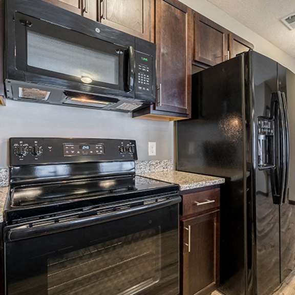 Thumbnail 3 of 9 Kitchen with GE appliances and microwave at North Pointe Villas