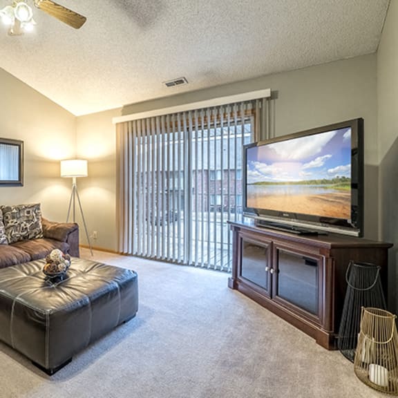 Thumbnail 2 of 9 Living room with large sliding doors at Fountain Glen Apartments