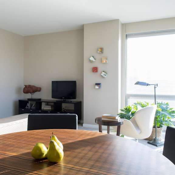 Thumbnail 4 of 10 living room and dining space with huge corner windows