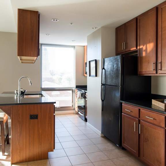 Thumbnail 2 of 10 Galley kitchen with black appliances and tons of cabinets