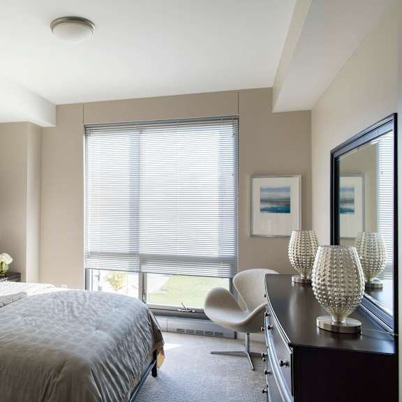 Thumbnail 7 of 10 Floor to ceiling windows allow for natural light to light up the bedrooms in Midtown Crossing apartments