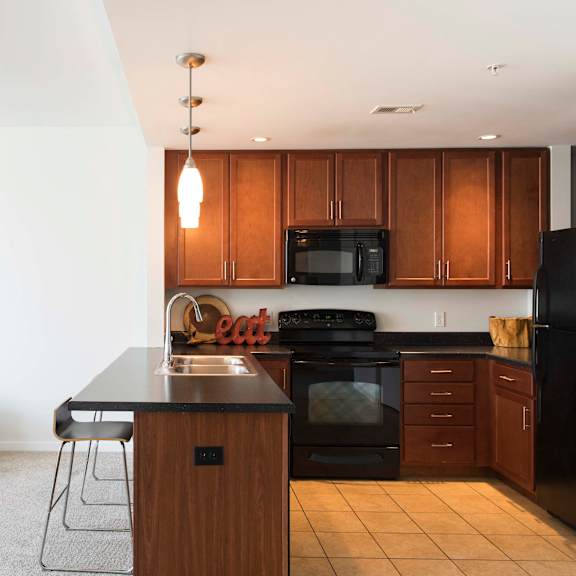 Thumbnail 3 of 8 fully equipped eat-in kitchen complete with seating at an attached breakfast bar
