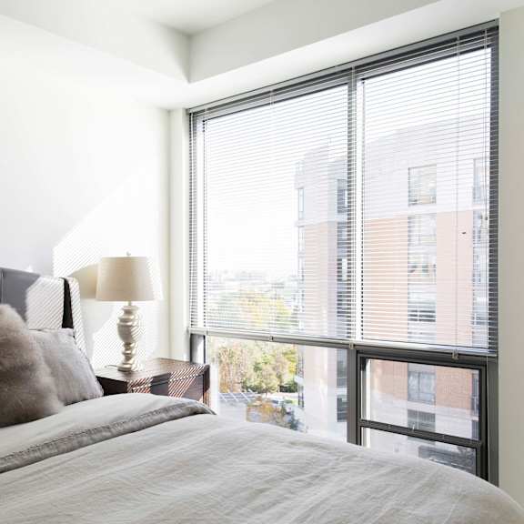 Thumbnail 7 of 8 Floor to ceiling windows in the bedrooms of Midtown Crossing apartments provide plenty of natural light in the rooms