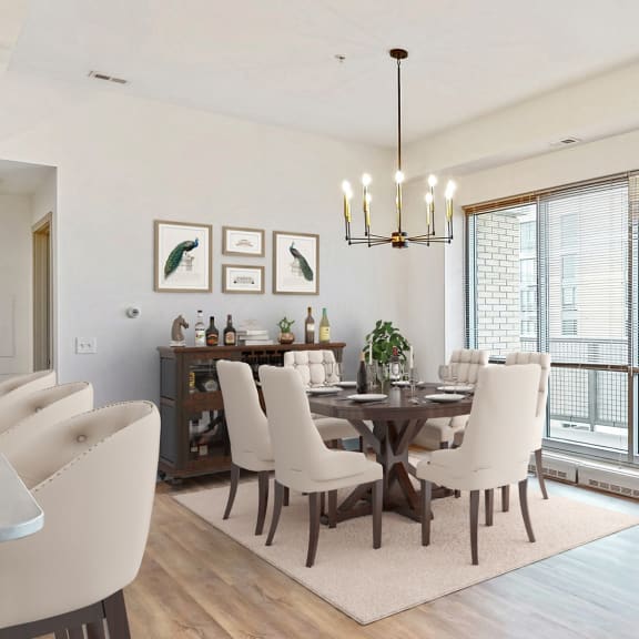 Thumbnail 7 of 22 Enjoy the scenic views from the floor-to-ceiling windows in the dining and living area of a 2 bedroom penthouse floor plan at Midtown Crossing Apartments Omaha