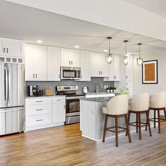Thumbnail 3 of 22 expansive kitchen with white cabinets and stainless steel appliances