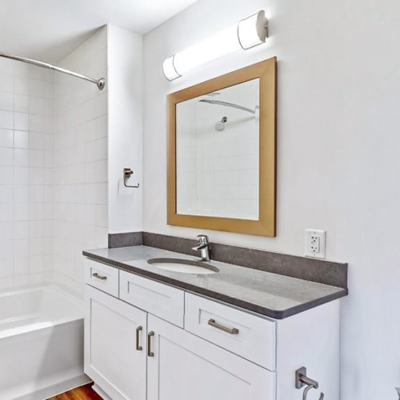 Thumbnail 10 of 22 Spacious bathroom with tub and shower and large vanity in a 2 bedroom penthouse floor plan Midtown Crossing Apartments Omaha