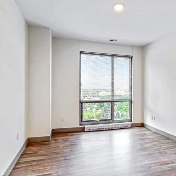 Thumbnail 16 of 22 Spacious bedroom with floor-to-ceiling windows a 2 bedroom penthouse floor plan Midtown Crossing Apartments Omaha